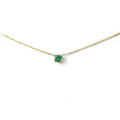 14k gold natural round shaped emerald set in a 4 prong setting with a delicate chain floating 