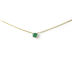 14k gold natural round shaped emerald set in a 4 prong setting with a delicate chain floating 