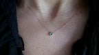14k gold sliding emerald necklace on the neck
