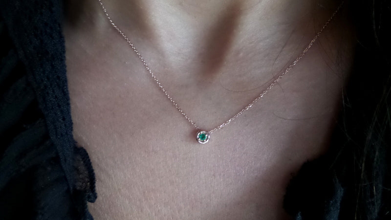 14k gold sliding emerald necklace on the neck
