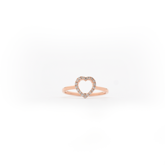 A 14k yellow gold diamond heart ring with a small heart-shaped diamond in the center, set on a plain band.