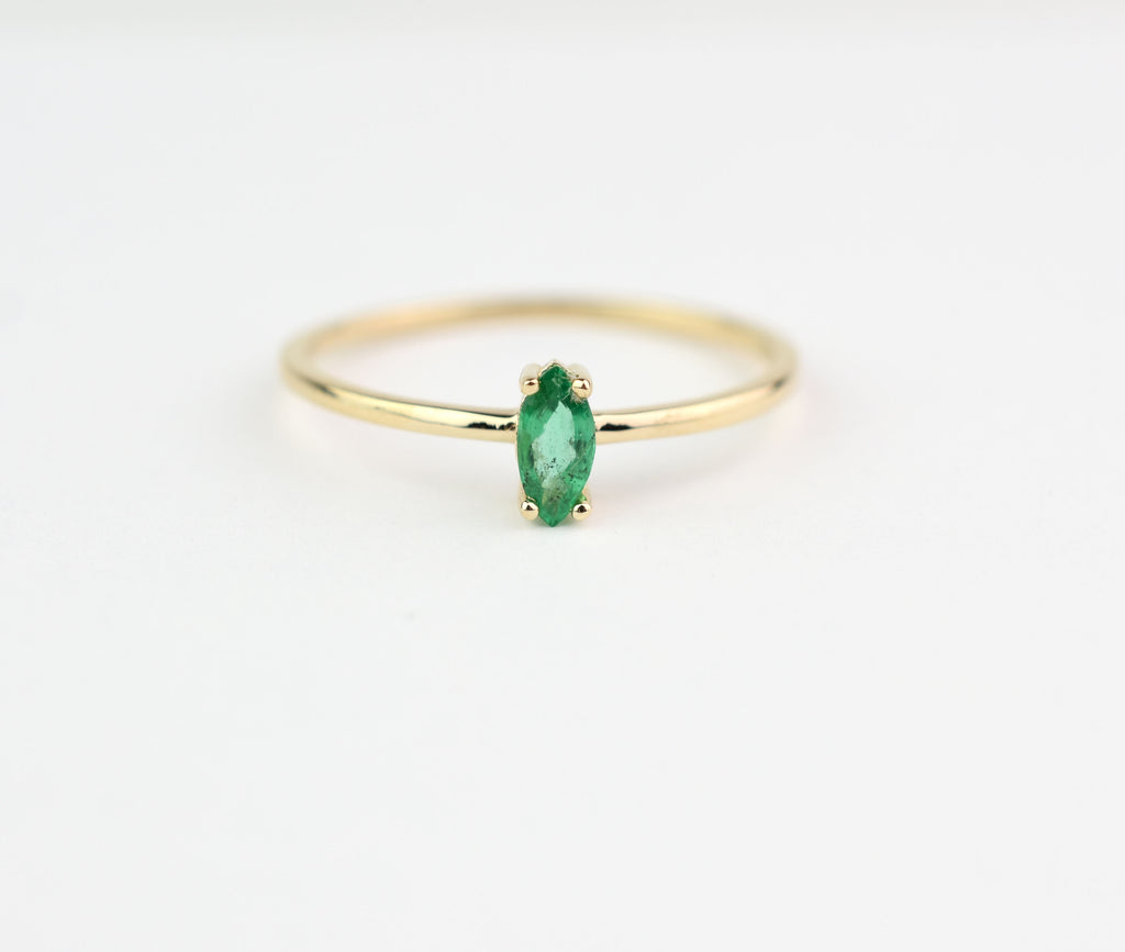 14k gold marquise shaped natural emerald set in a 4 prong setting 