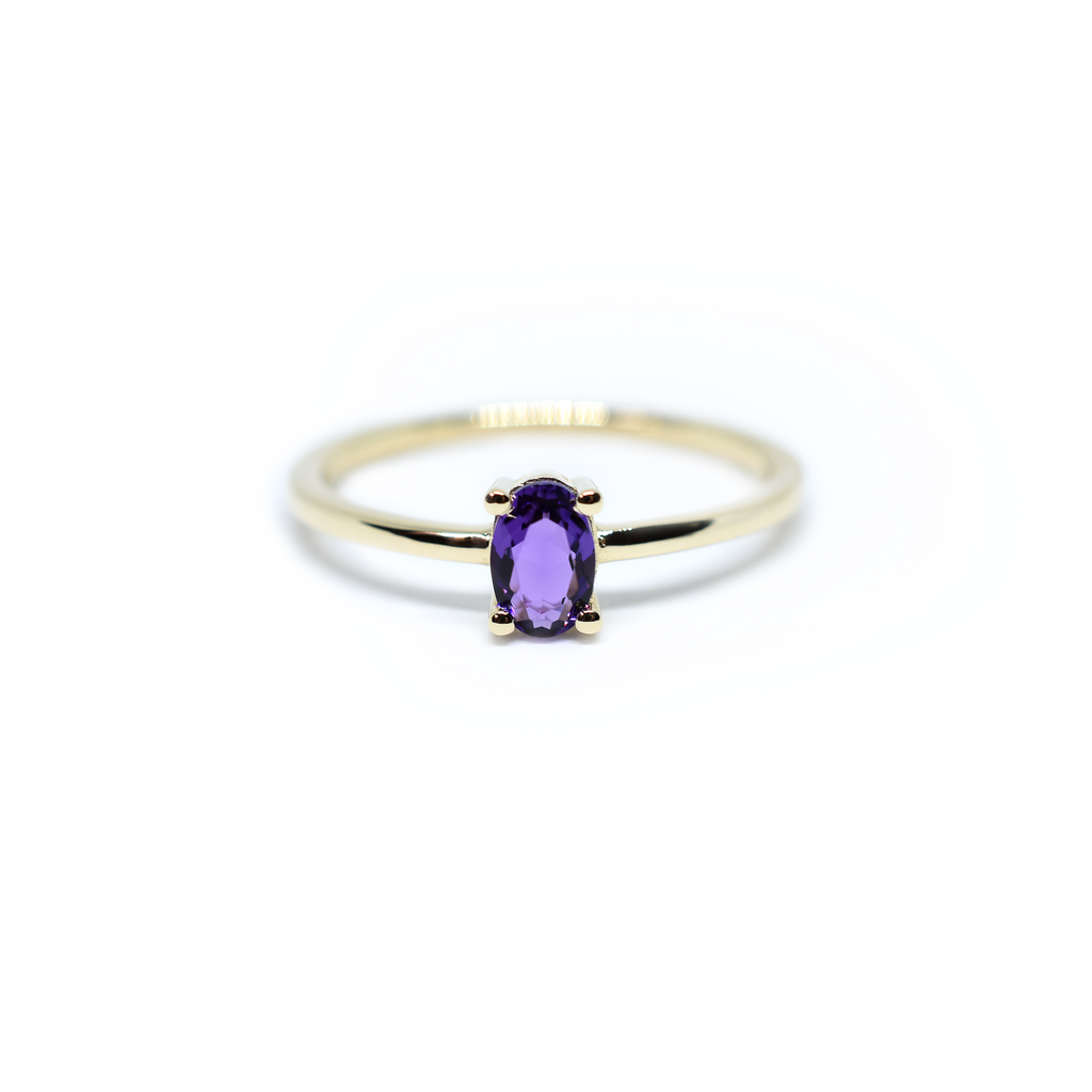 14k gold and oval Amethyst solitaire ring in white background