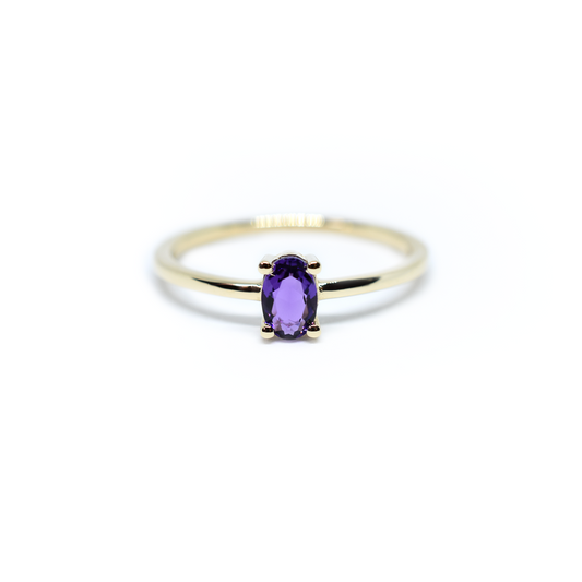 14k gold and oval Amethyst solitaire ring in white background