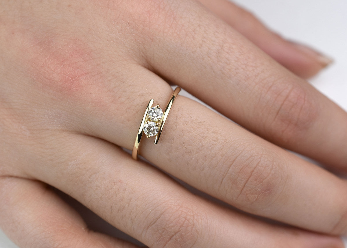 14k yellow gold two-stone diamond bypass ring with round-cut natural diamonds, elegant anniversary jewelry"