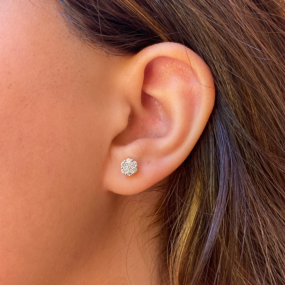 diamond flower cluster earrings on a model